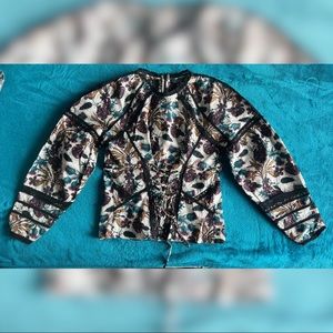 Topshop top with back zipper and lace like details. Size 6.